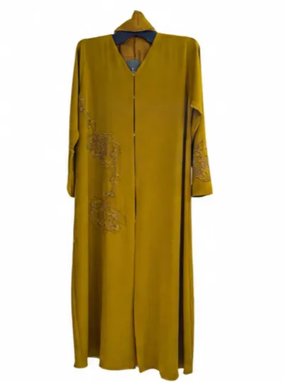 A front-open floor-length abaya styled in a dusty rose (or tea pink) shade