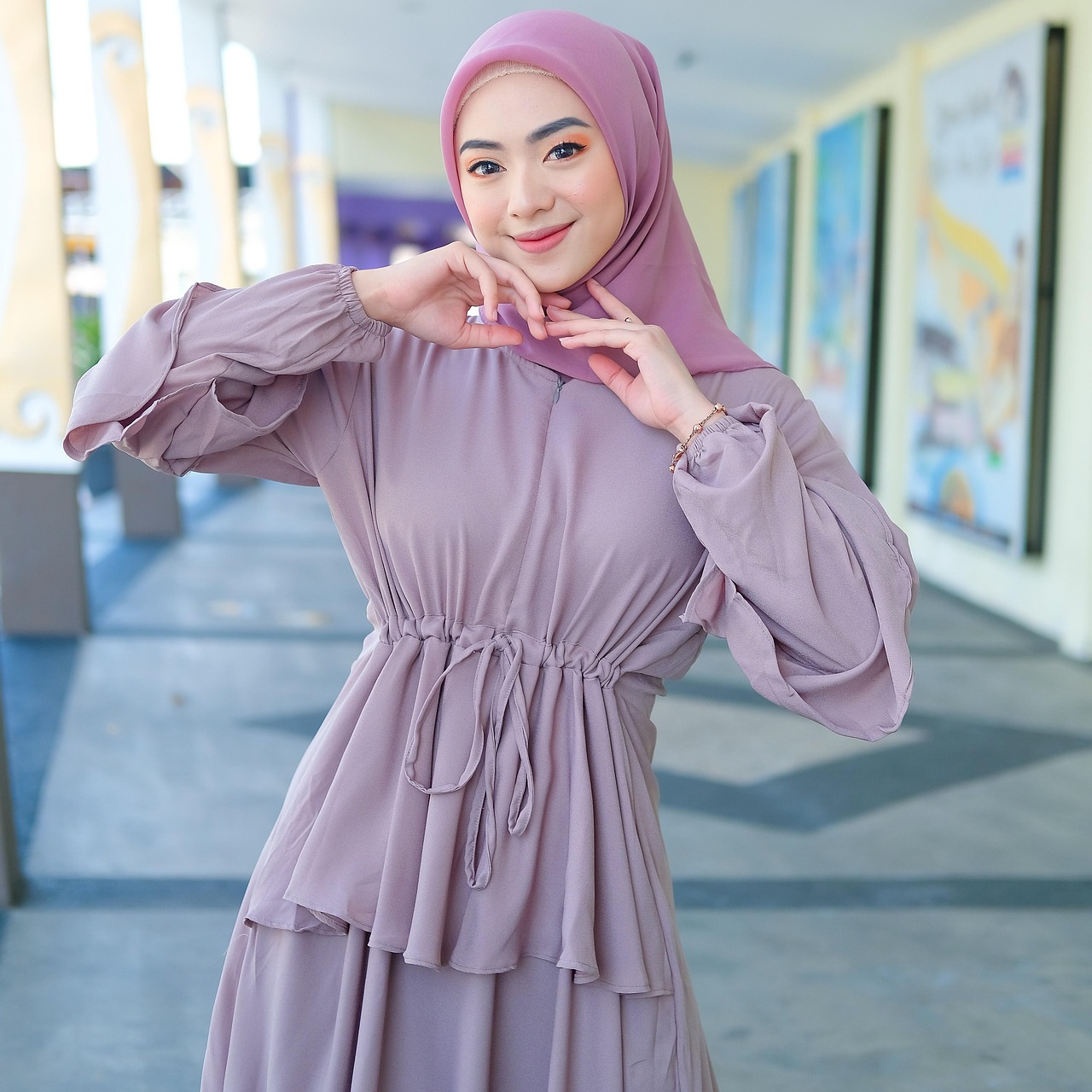 A light grey or sage green modern ,elegant, full-length Abaya designed in a light sage green or light grey hue